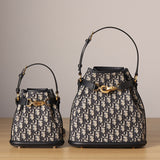 Front view of used restored Dior CD Bucket Bags in two sizes by Empyrean Atelier, featuring navy Oblique canvas, gold-tone hardware, and structured silhouette.