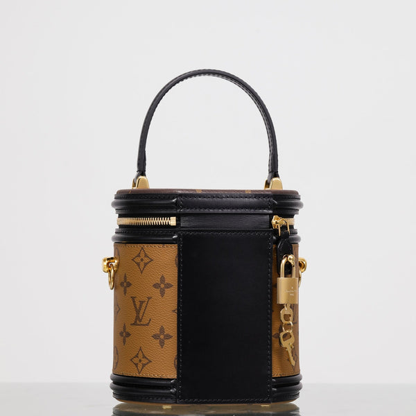 Front view of restored pre-owned Louis Vuitton Cannes vanity bag by Empyrean Atelier, featuring Monogram canvas, black leather trim, gold-tone hardware, and signature lock detail.