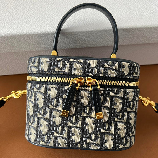 Front view of restored used Dior CD Signature Vanity Bag by Empyrean Atelier, featuring Oblique canvas and dual zip closure with gold-tone details.