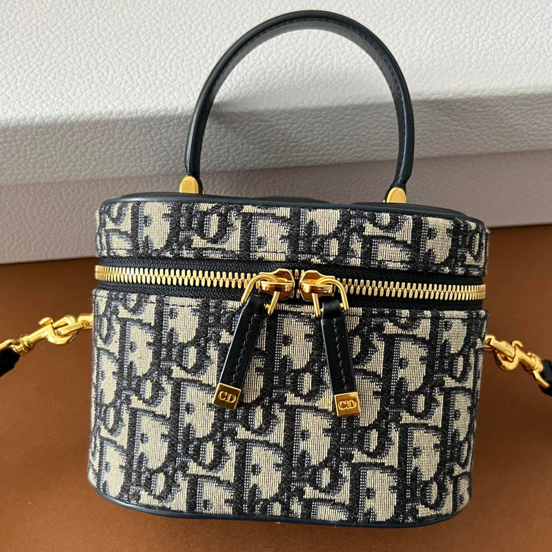 Front view of restored used Dior CD Signature Vanity Bag by Empyrean Atelier, featuring Oblique canvas and dual zip closure with gold-tone details.