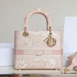 Pre-owned restored Christian Dior Lady Dior handbag in pink embroidery with gold hardware, expertly refinished by Empyrean Atelier.