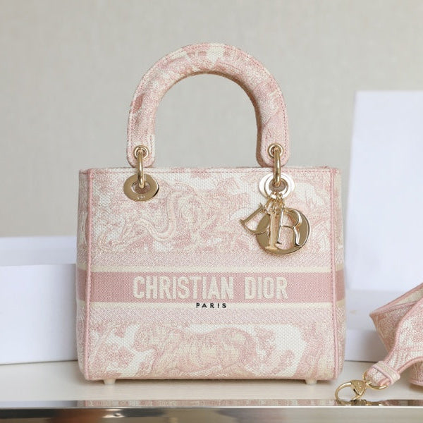 Pre-owned restored Christian Dior Lady Dior handbag in pink embroidery with gold hardware, expertly refinished by Empyrean Atelier.