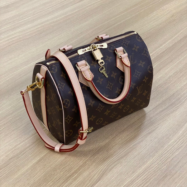 Pre-owned restored Louis Vuitton Speedy 25 bag in Monogram canvas with vachetta leather and gold-tone lock, restored by Empyrean Atelier