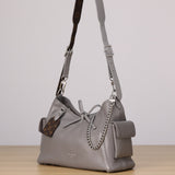 Pre-owned restored Louis Vuitton CarryAll Cargo Vibe PM in grey leather with Monogram shoulder strap and chain accent, restored by Empyrean Atelier