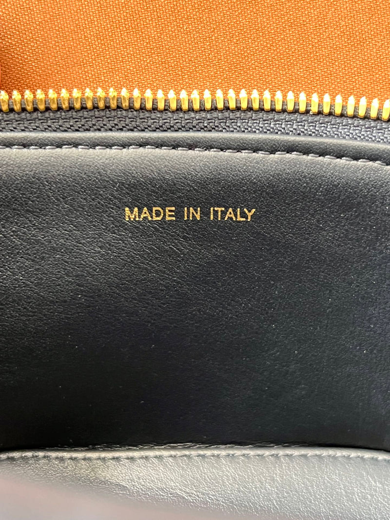 Interior detail of restored used Dior CD Signature Vanity Bag with ‘Made in Italy’ stamp, highlighting authentic lining and restoration finish.